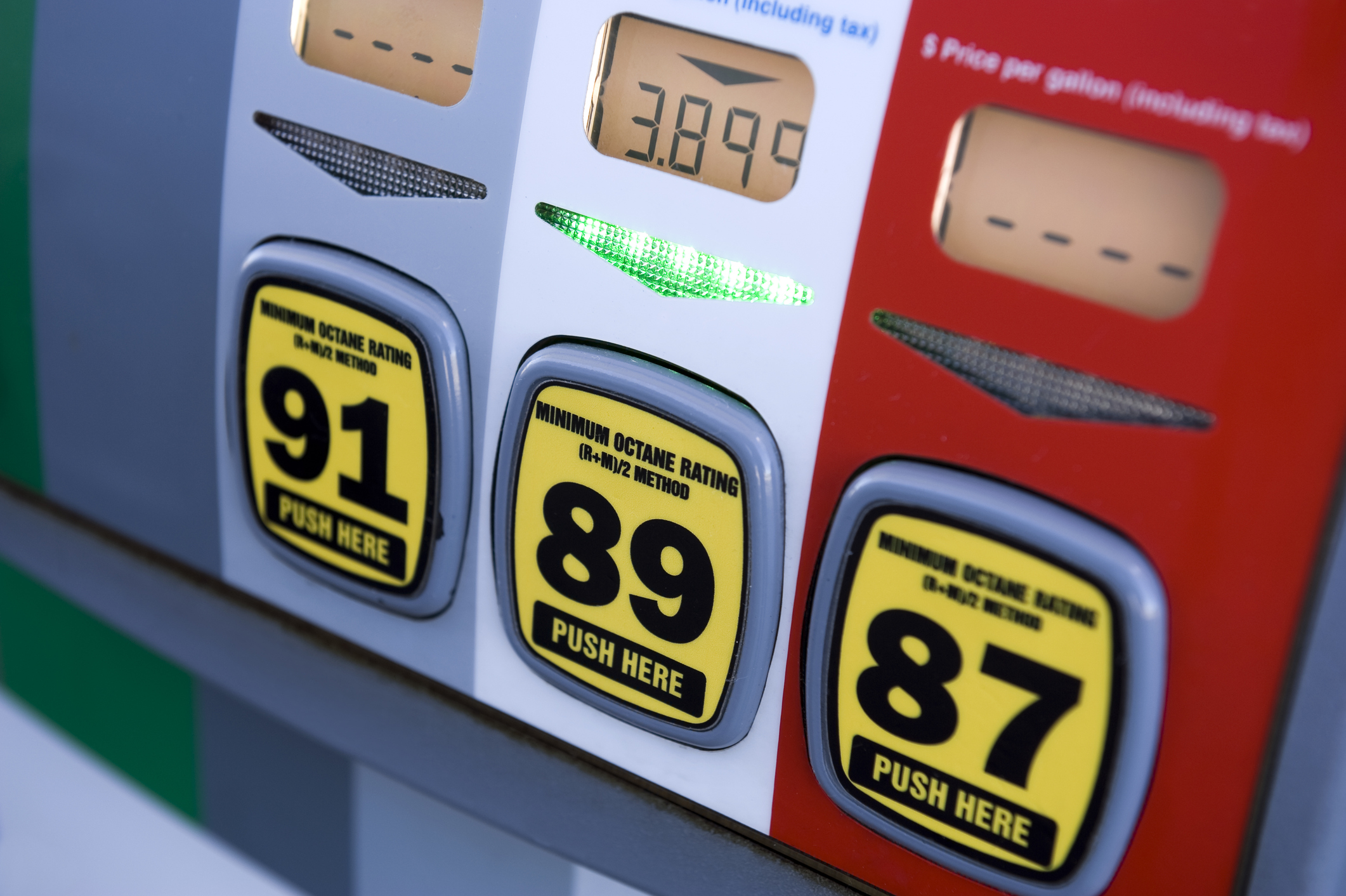 Color-coded fuel dispenser graphics and octane decals on a gas pump